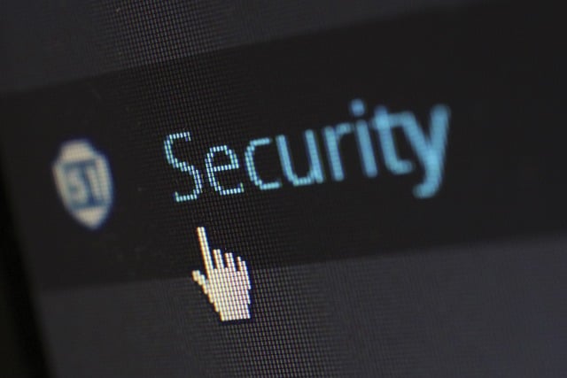 An image with the word "security" and a small hand with the finger pointing at the word.